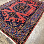 Persian Vise rug 7'2"x9'6", diagonal view of red pattern and navy edge border