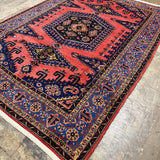 Persian Vise rug 7'2"x9'6", diagonal view of red pattern and navy edge border