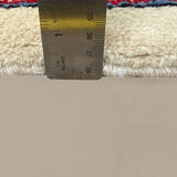 Vintage Arak Boteh Mir Rug, side-on pile and edge detail with a ruler, hand-knotted wool pile. SKU PP 100232.