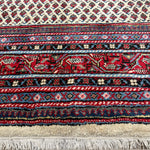 Vintage Arak Boteh Mir Rug, close-up of the border and fringe, hand-knotted wool pile. SKU PP 100232.