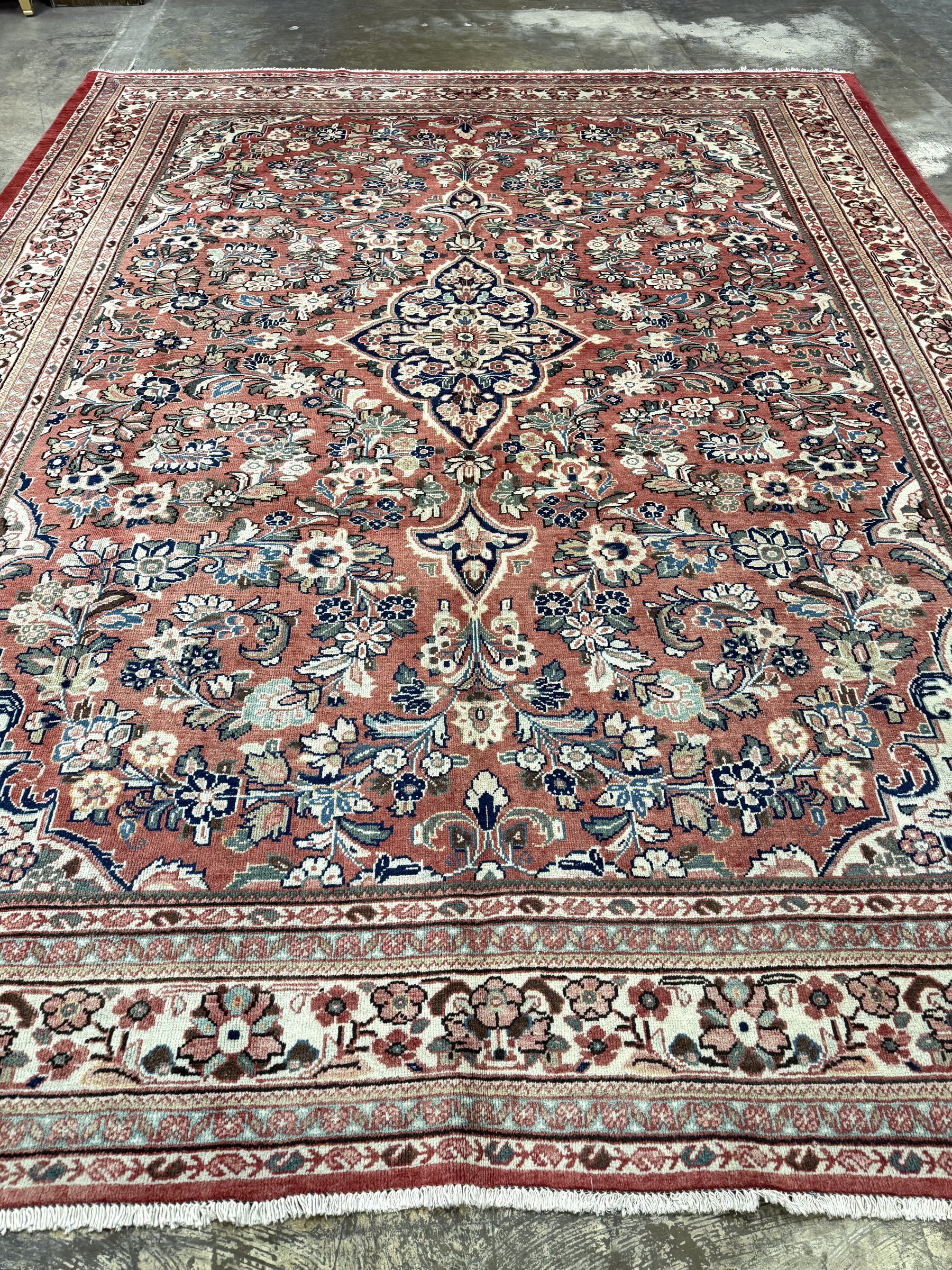 Persian Mahal rug with central medallion and scrolling floral patterns on rose background