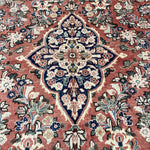 Persian Mahal rug close-up of navy medallion with red and cream floral accents
