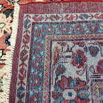 Persian Mahal rug border close-up with blue details and fringed cream edge
