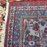 Persian Mahal rug border close-up with blue details and fringed cream edge