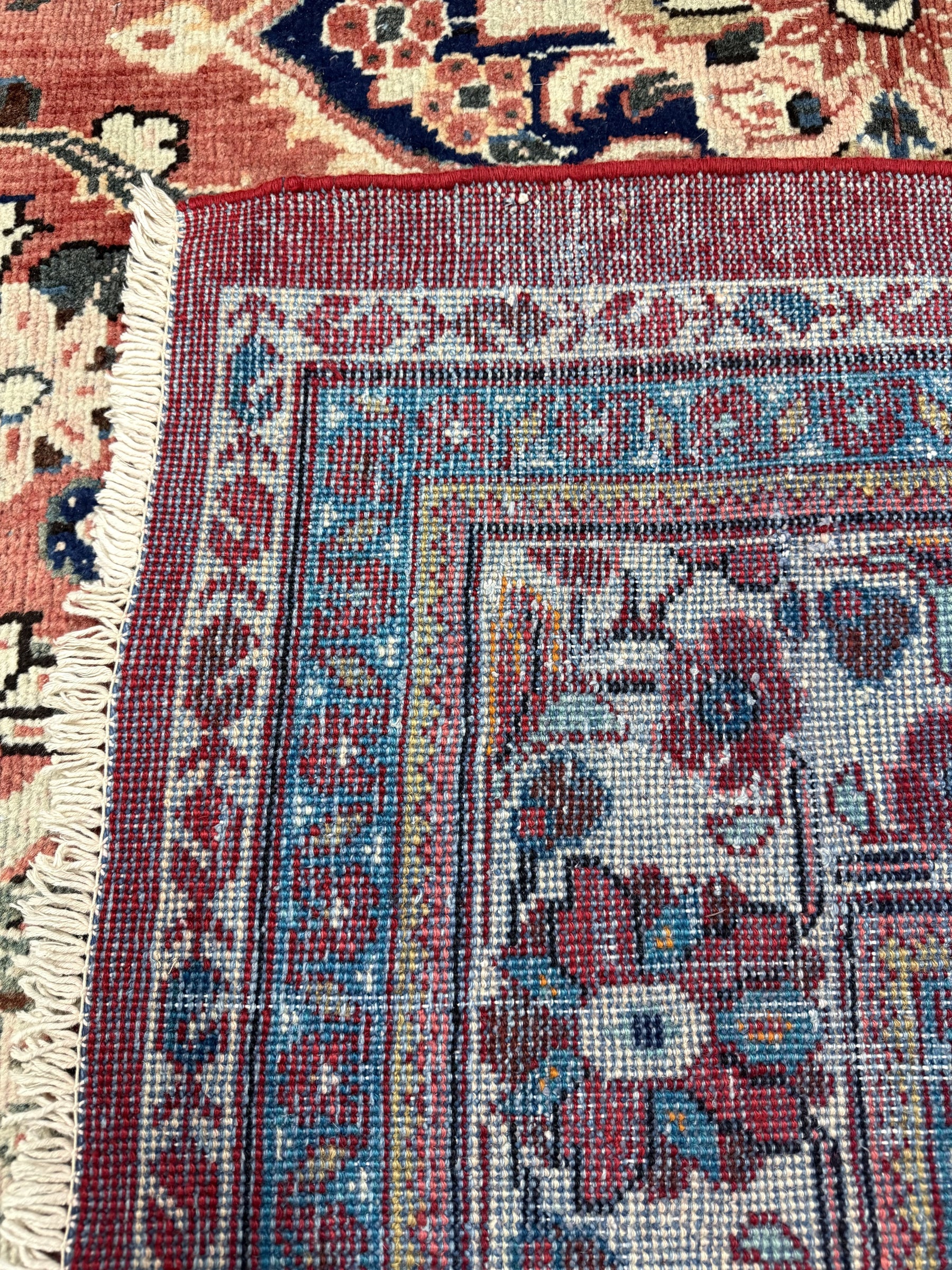 Persian Mahal rug border close-up with blue details and fringed cream edge