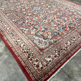 Persian Mahal rug, full view angled, rose field with ornate blue medallion and border