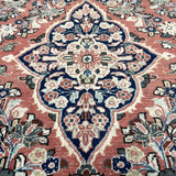Persian-style rug with central blue-and-cream medallion on rust background, detailed florals