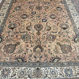 Persian Tabriz rug with central medallion, dusty beige tones and dark blue edging