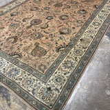 Persian Tabriz rug corner view, beige field with teal floral vines and ivory border