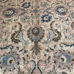 Persian Tabriz rug close-up center motif, beige background with blue and teal accents