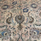 Persian Tabriz rug close-up center motif, beige background with blue and teal accents