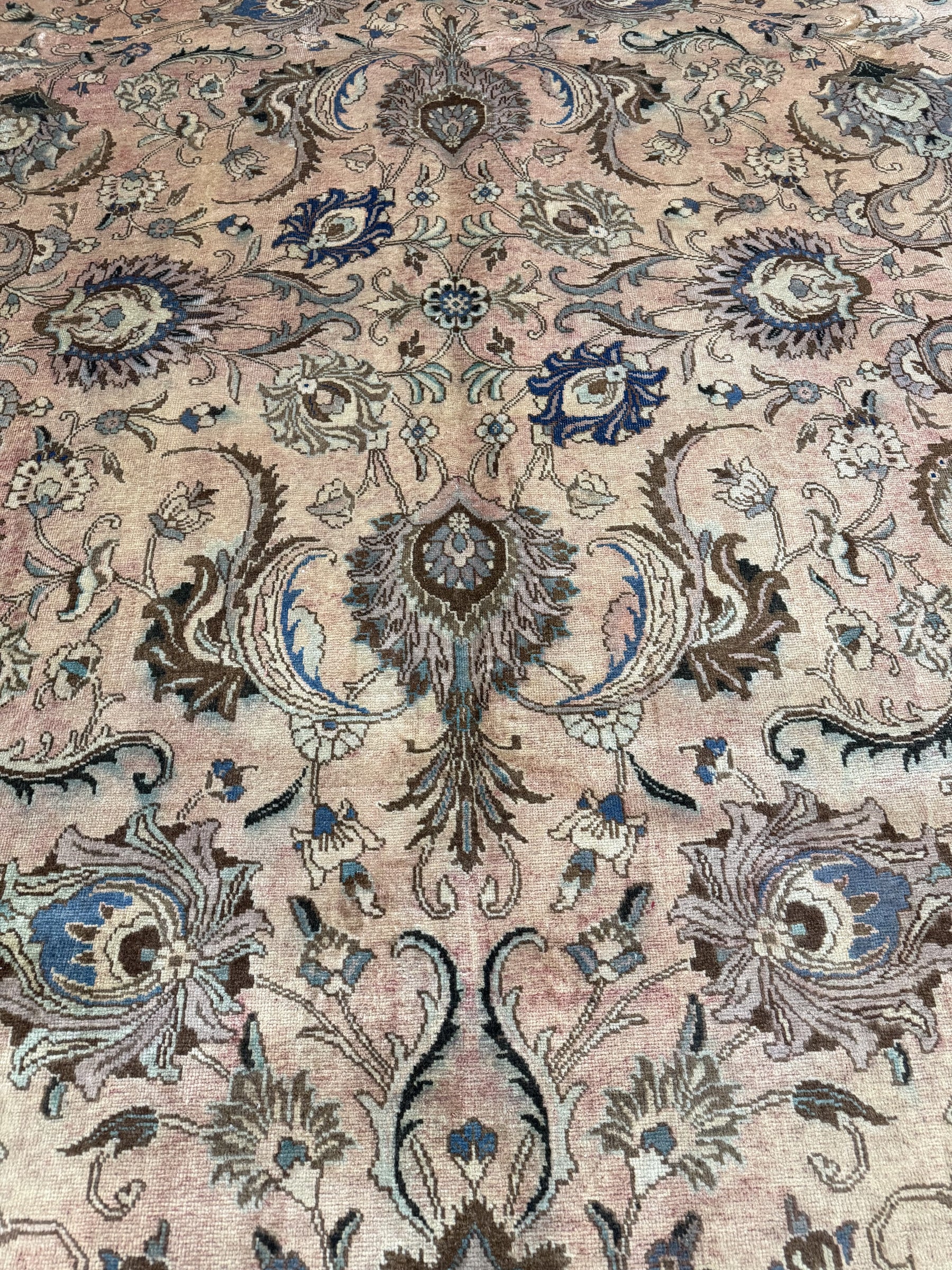 Persian Tabriz rug close-up center motif, beige background with blue and teal accents
