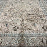 Tabriz-style rug, cream tone with teal-blue border stripes and ornate floral layout.