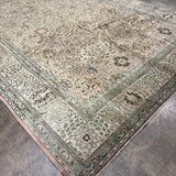 Persian-style Tabriz rug with cream field, blue corner medallions, and patterned border