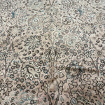 Floral all-over pattern rug in cream with small blue and dark motifs
