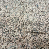 Floral all-over pattern rug in cream with small blue and dark motifs