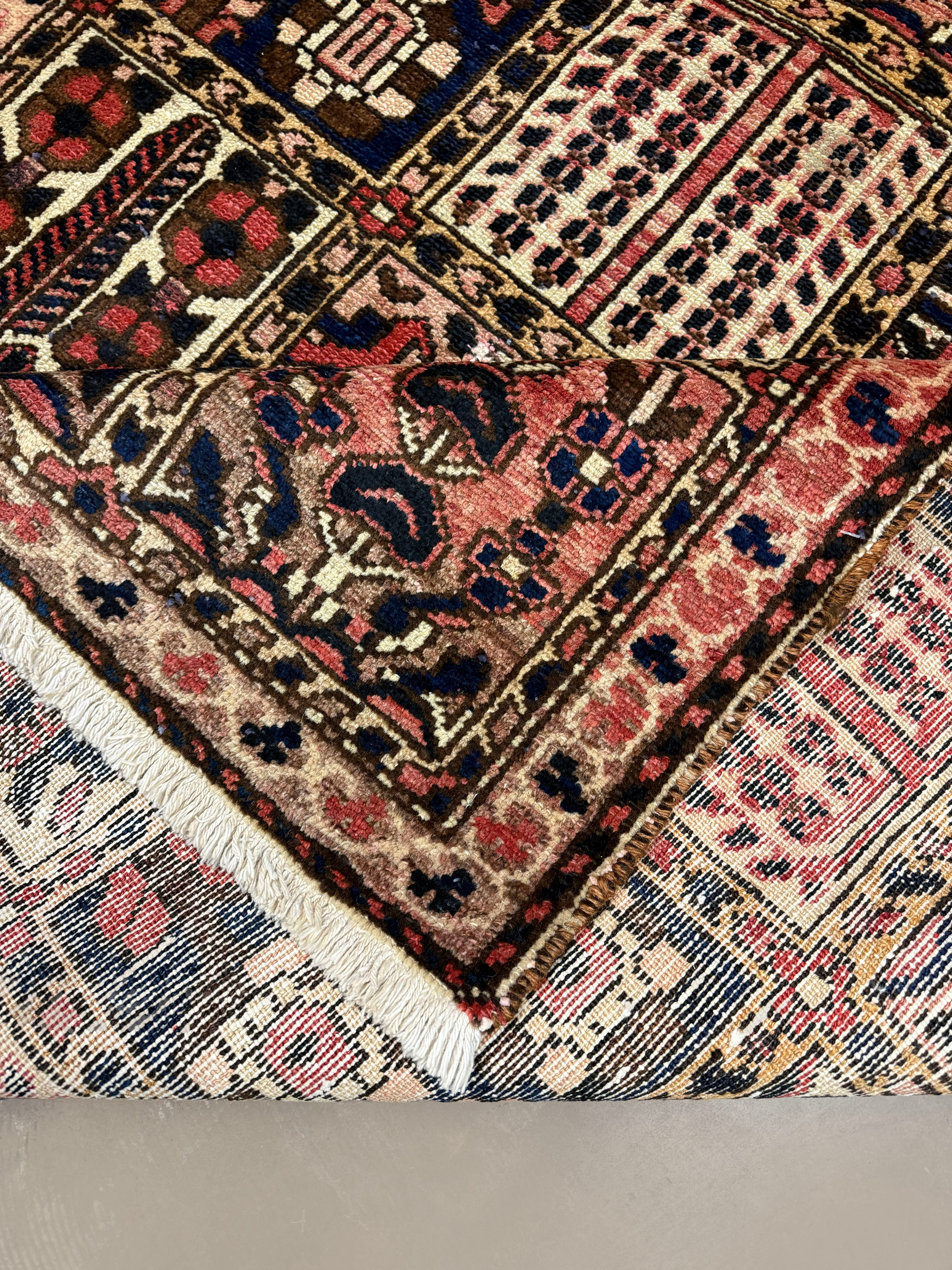 Persian Shalamzar Bakhtiari Rug, folded corner and reverse, hand-knotted wool with red colouring. SKU RR 32416.