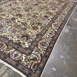 Tabriz rug corner with red and blue floral motifs, dark navy border stripe, fringe