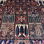 Bakhtiari Persian rug close-up grid of navy, red and cream geometric tile motifs