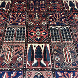 Bakhtiari Persian rug close-up grid of navy, red and cream geometric tile motifs