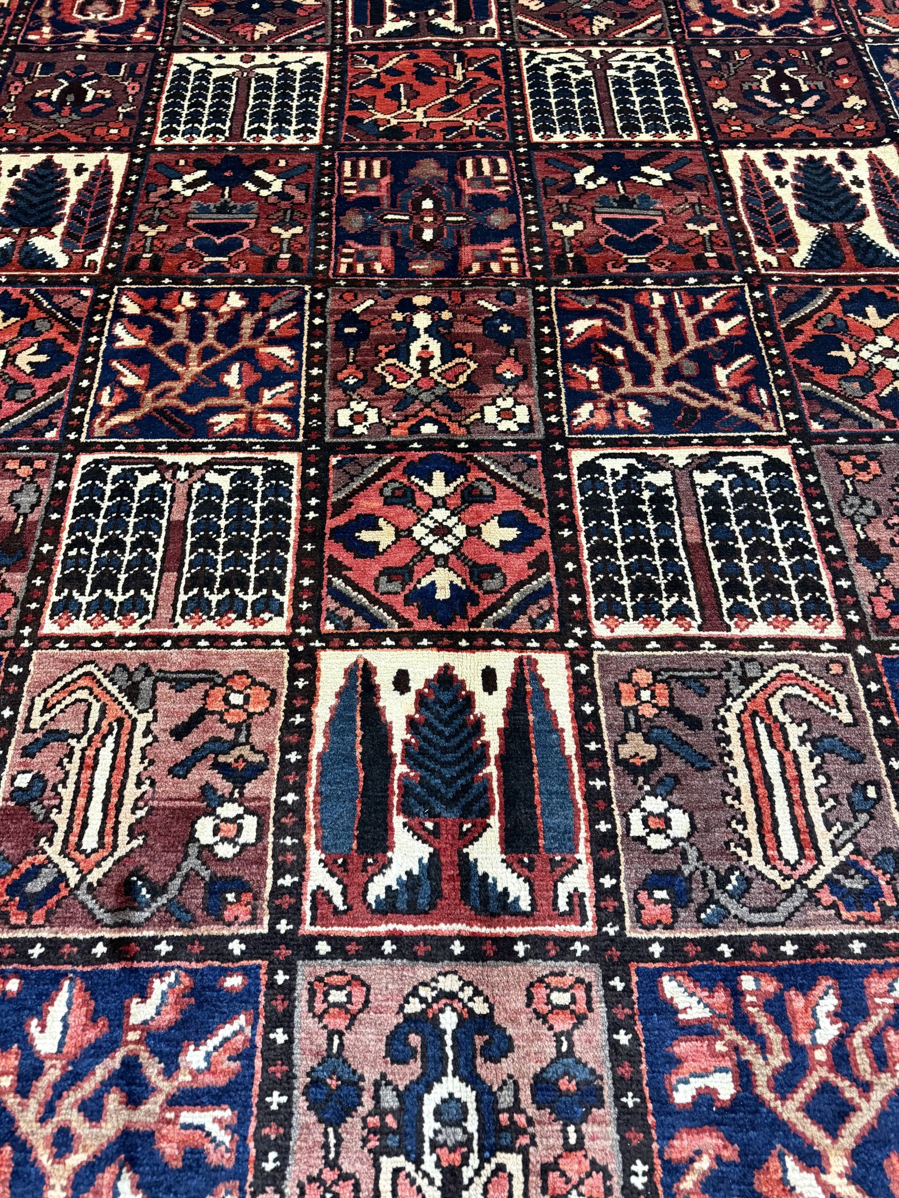 Bakhtiari Persian rug close-up grid of navy, red and cream geometric tile motifs