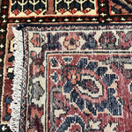 Bakhtiari Persian rug close-up of cream and red centerpiece with navy surrounding details