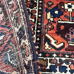 Bakhtiari Persian rug fabric and edge close-up with navy and red woven pattern