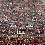 Bakhtiari Persian rug full view with red, navy, cream geometric layout and border
