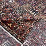 Multicolor geometric rug with navy, rust, cream and maroon blocks, fringed selvage edge
