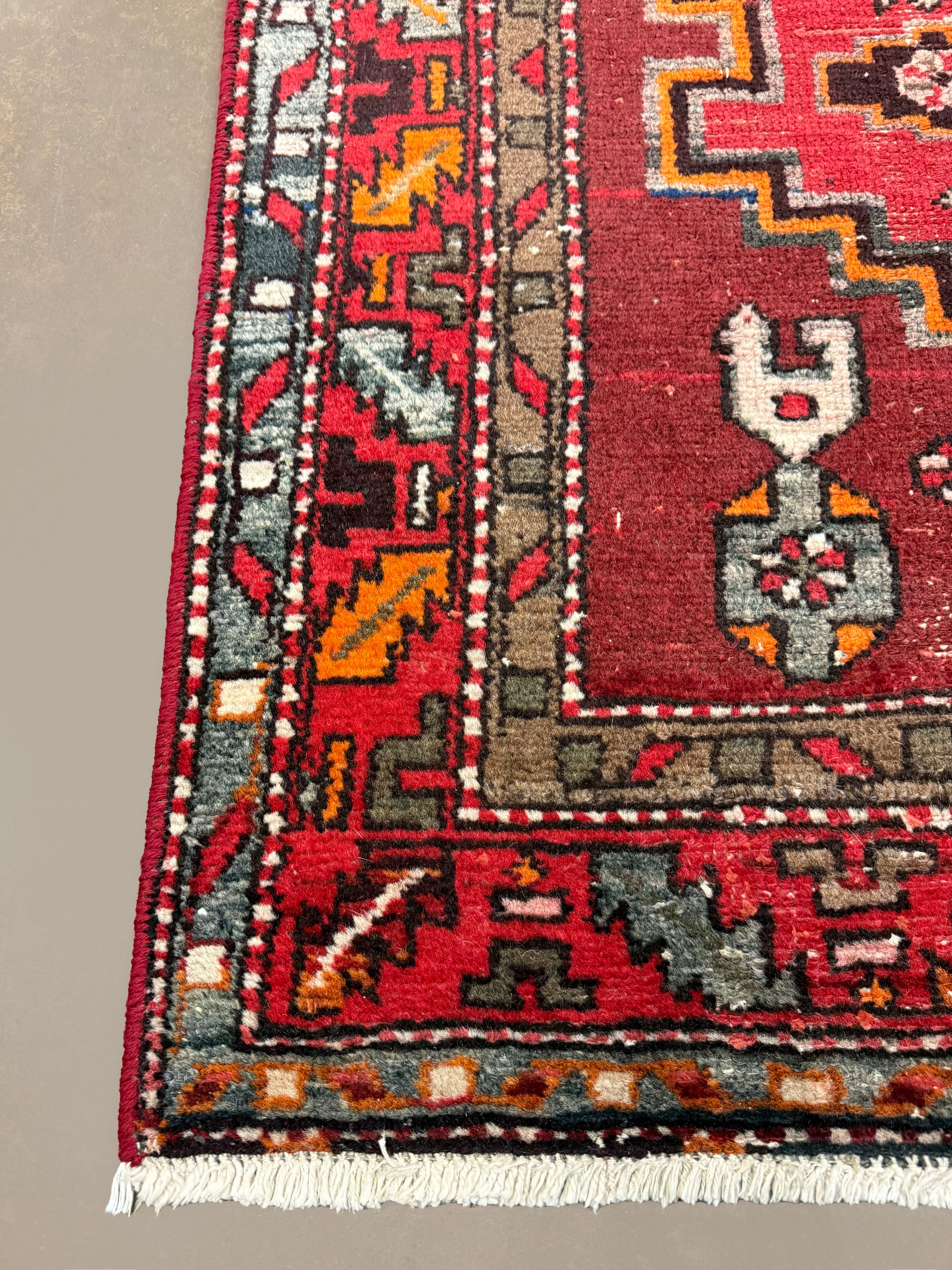 Persian Zanjan Rug, border and fringe detail, hand-knotted wool with red colouring. SKU RZ 101.