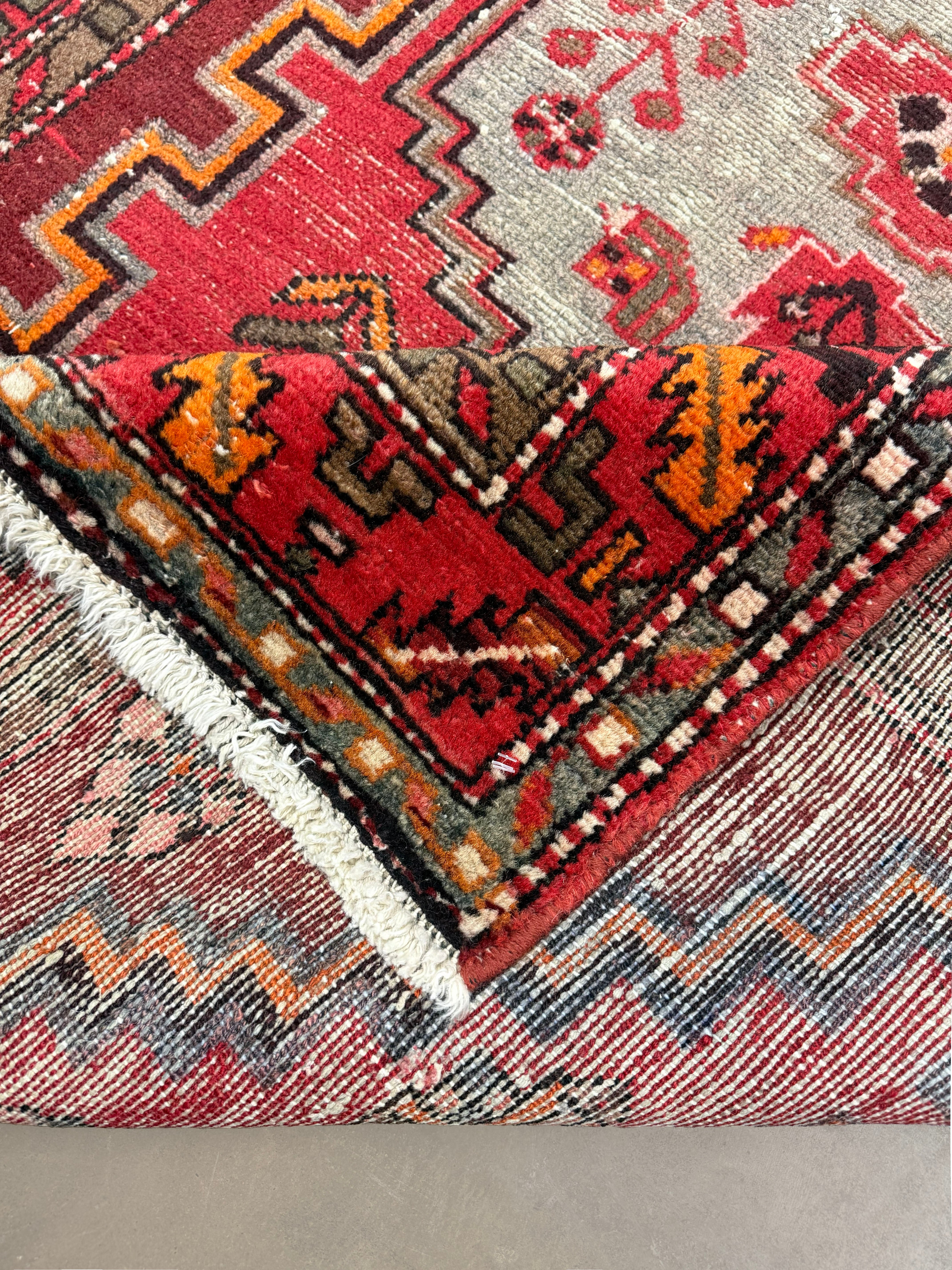 Persian Zanjan Rug, folded corner and reverse, hand-knotted wool with red colouring. SKU RZ 101.