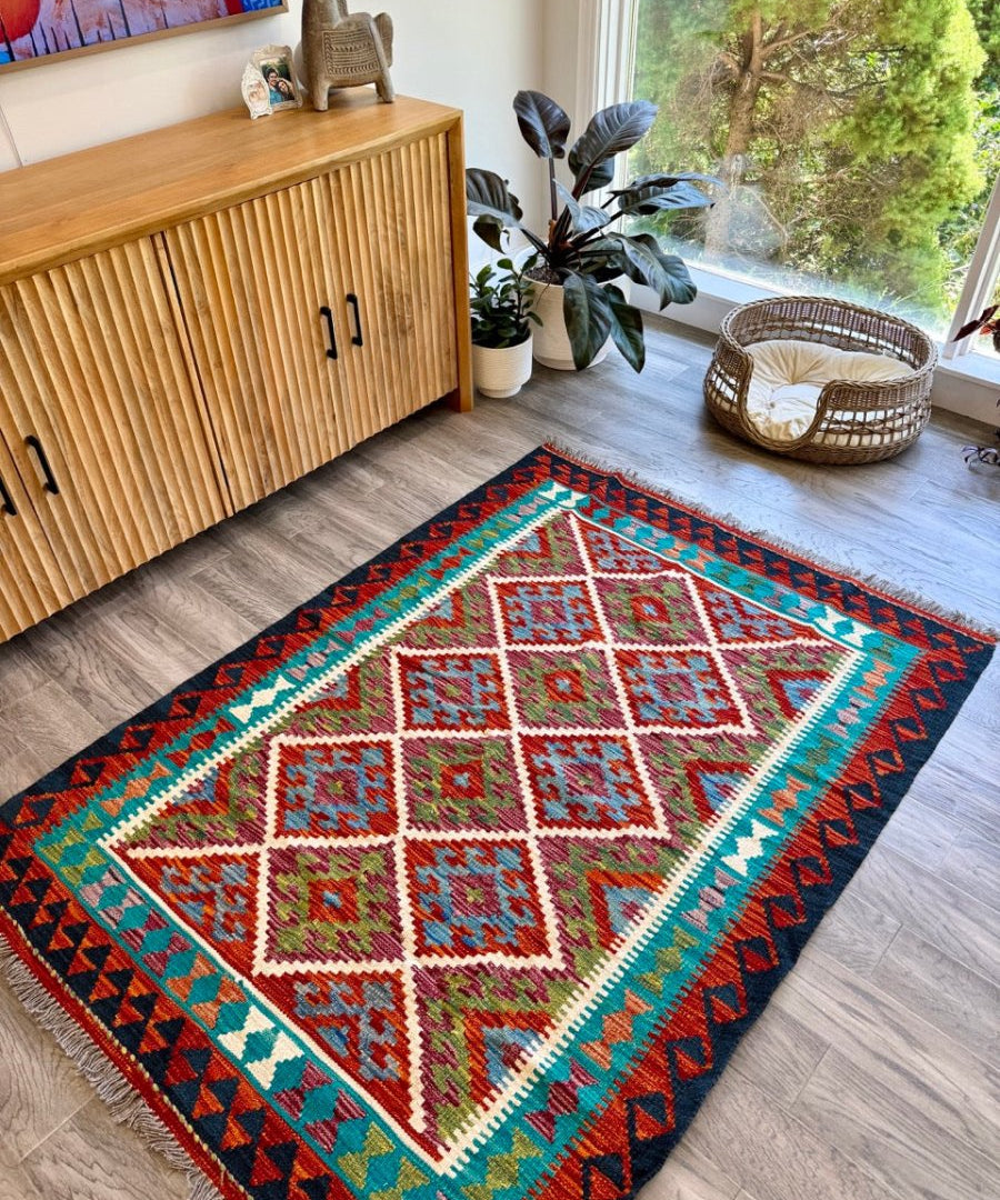 Afghan Chobi kilim rug with central diamond medallion and teal outer border