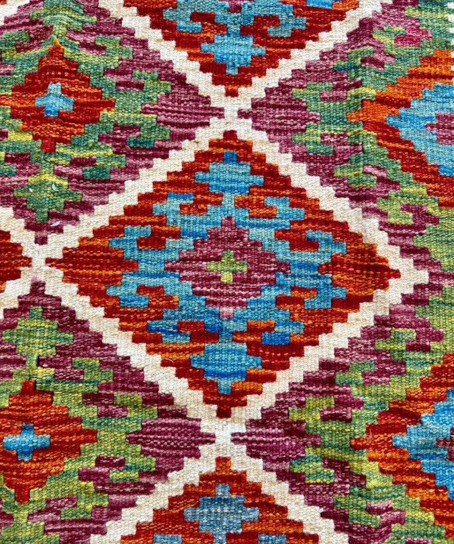 Afghan Chobi kilim rug close-up of crosshatch diamond motifs in blue, orange, green, red