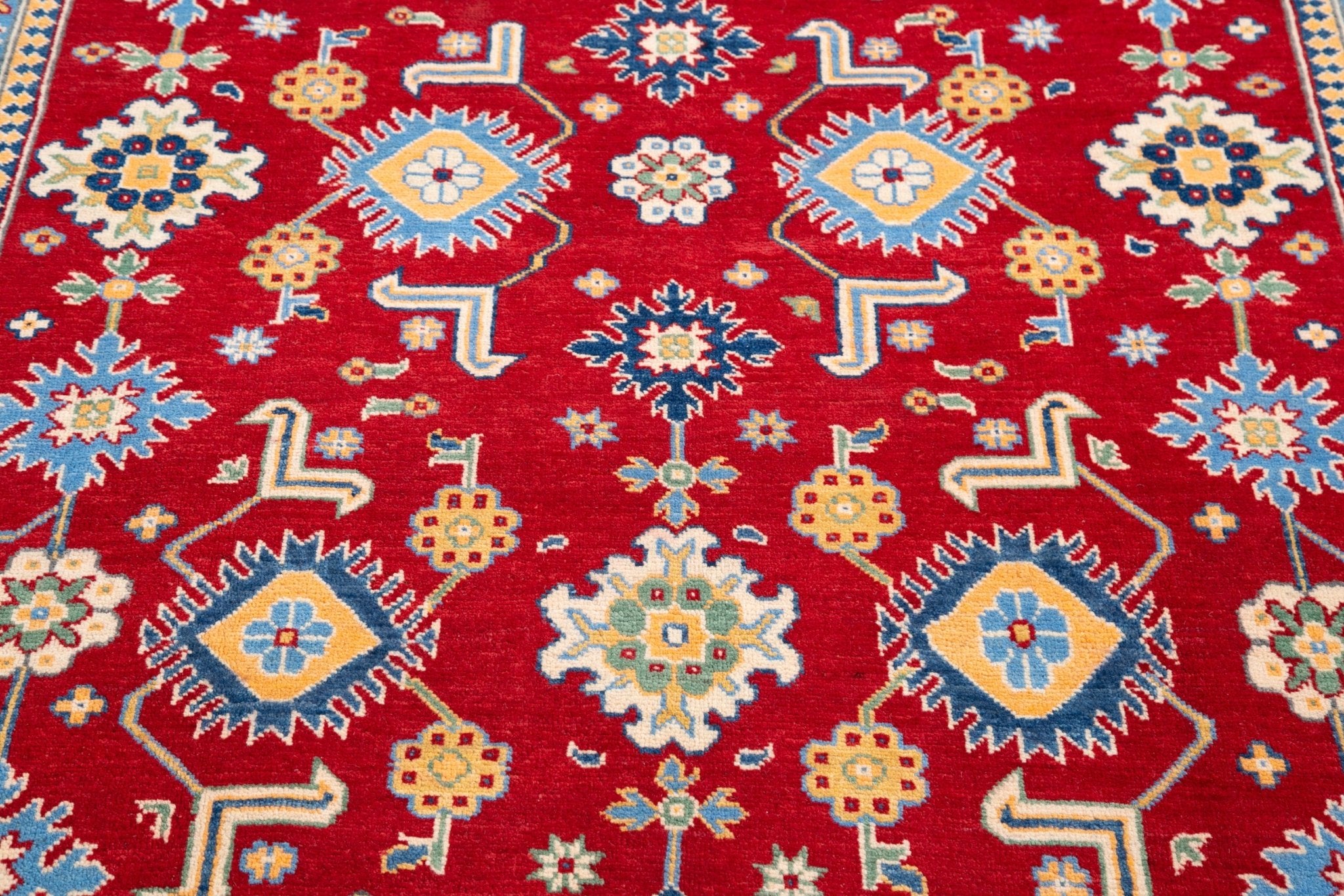 Pattern detail of red & blue Kazak-inspired wool rug 21542.