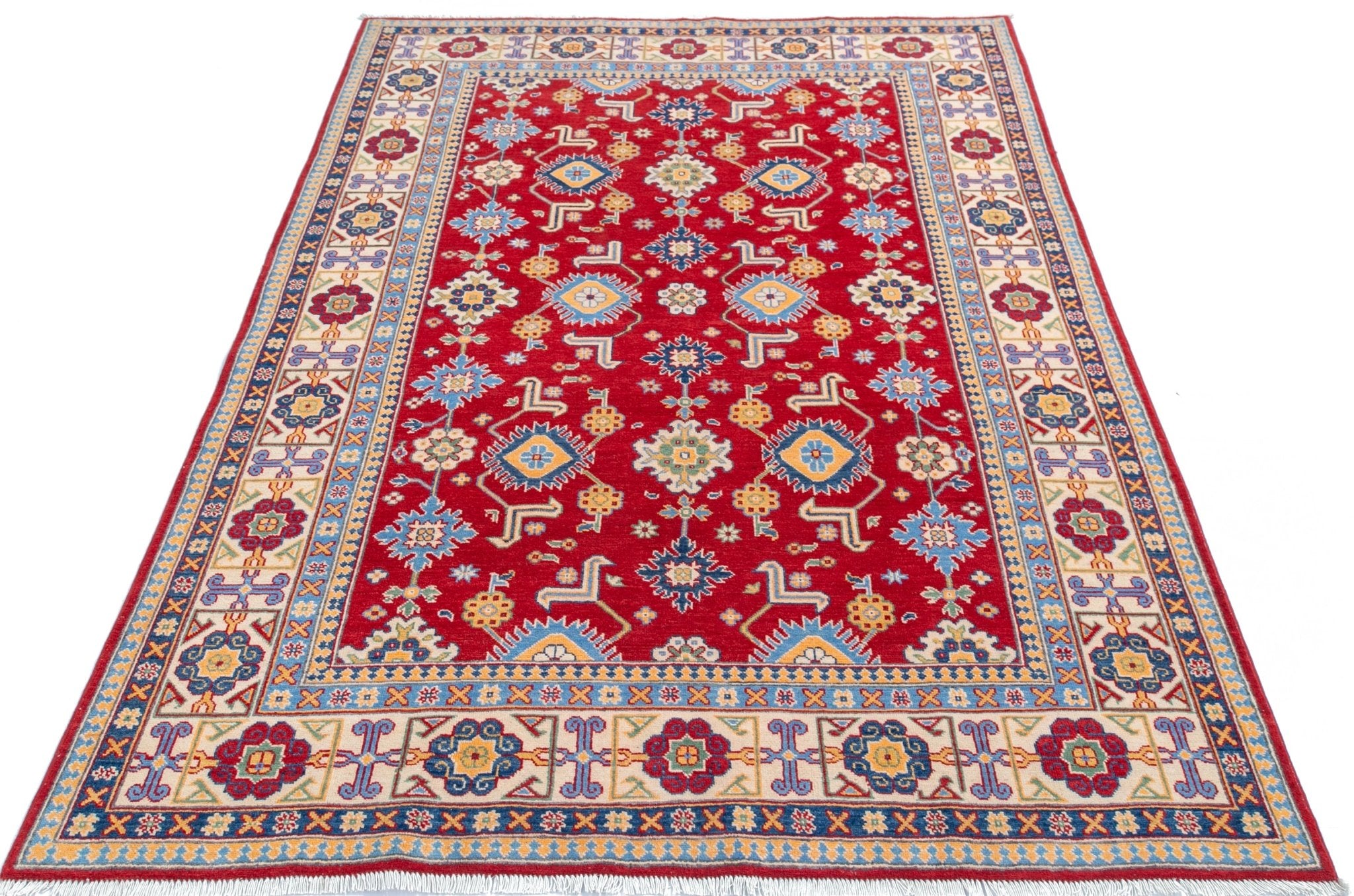 Full view from a low angle of red & blue Kazak-inspired wool rug 21542.