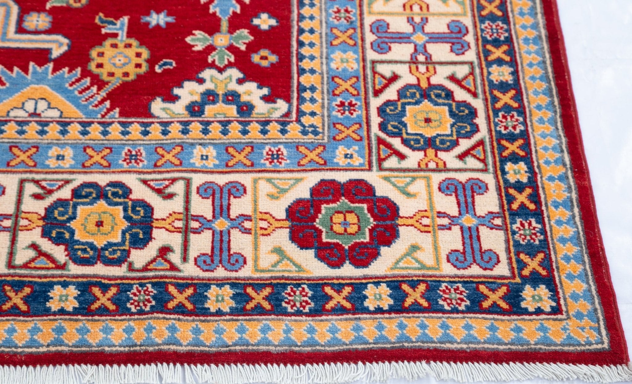 Border and edge detail of red & blue Kazak-inspired wool rug 21542.