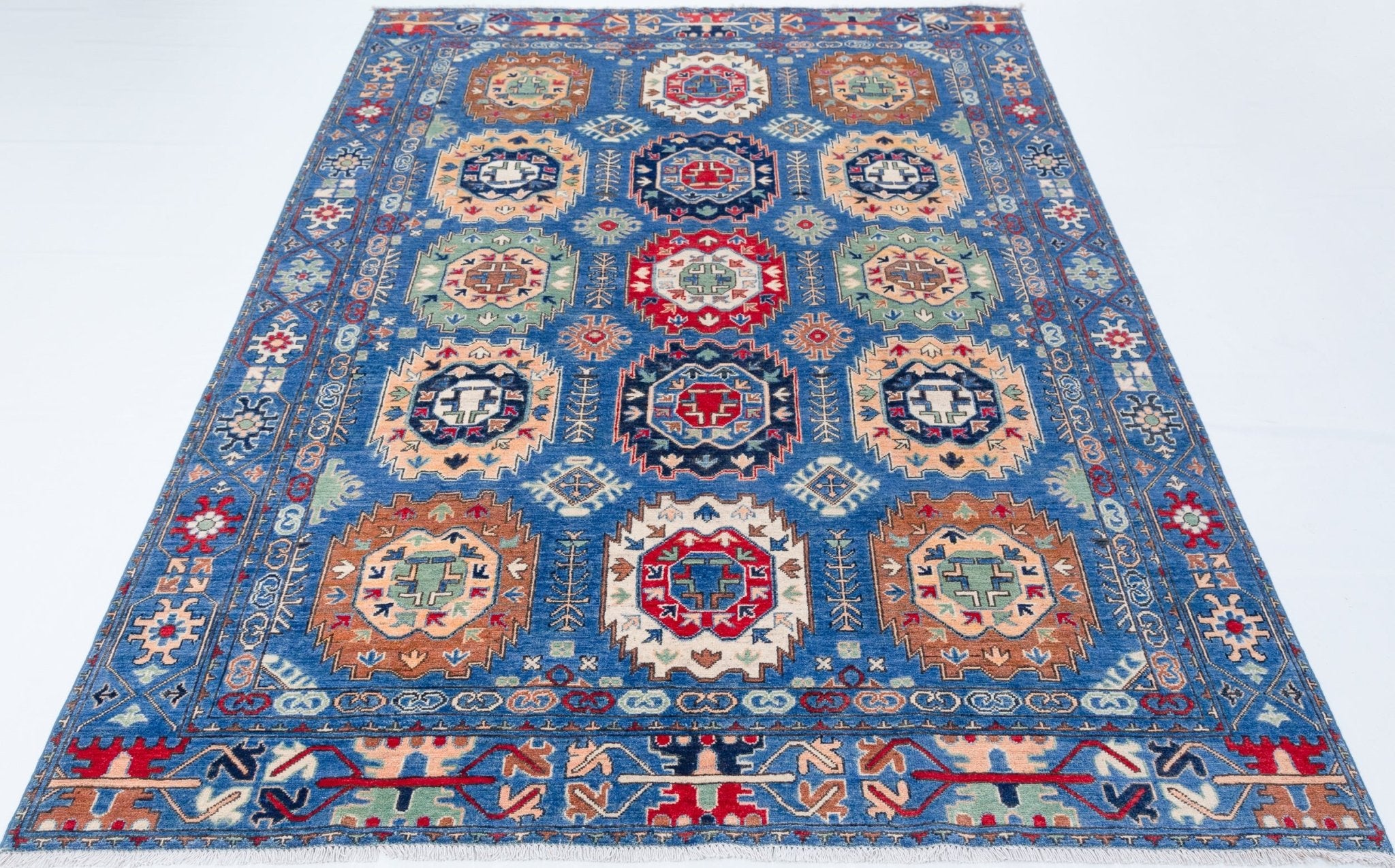 Full view from a low angle of blue & red Kazak-inspired wool rug 29635.