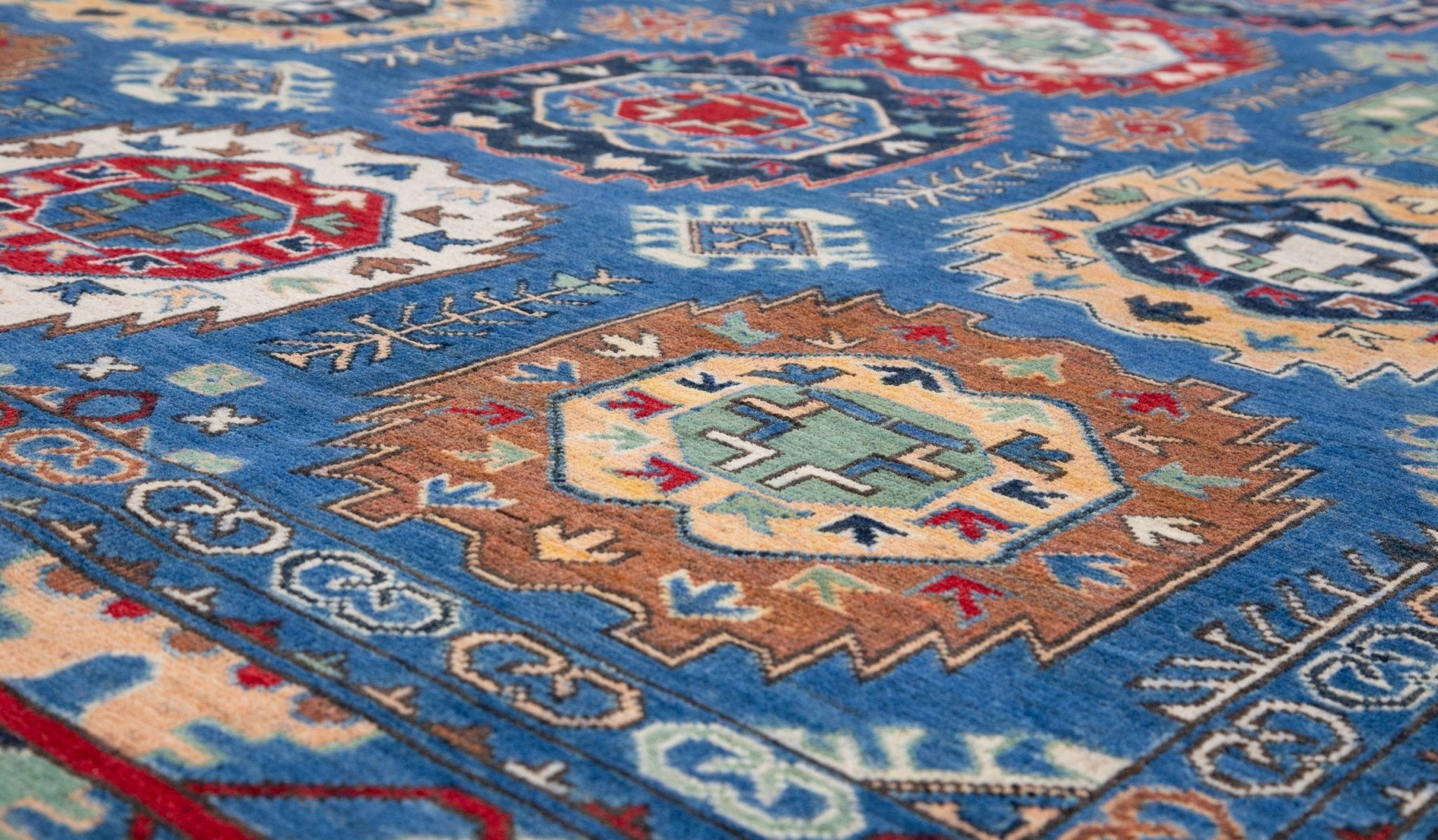 Pattern detail of blue & red Kazak-inspired wool rug 29635.