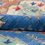 Folded edge and wool pile of blue & red Kazak-inspired wool rug 29635.