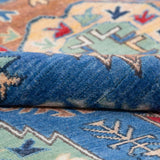Folded edge and wool pile of blue & red Kazak-inspired wool rug 29635.