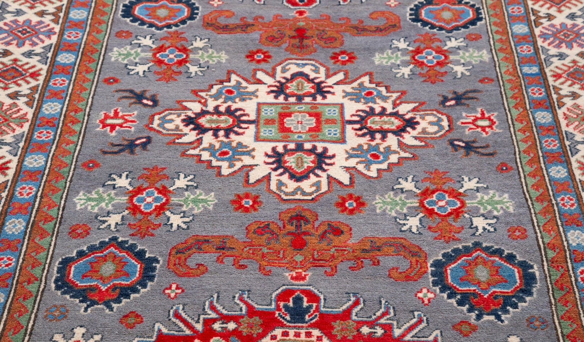 Pattern detail of blue & red Kazak-inspired wool rug 29345.