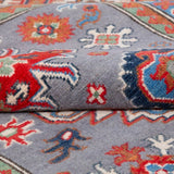 Folded edge and wool pile of blue & red Kazak-inspired wool rug 29345.