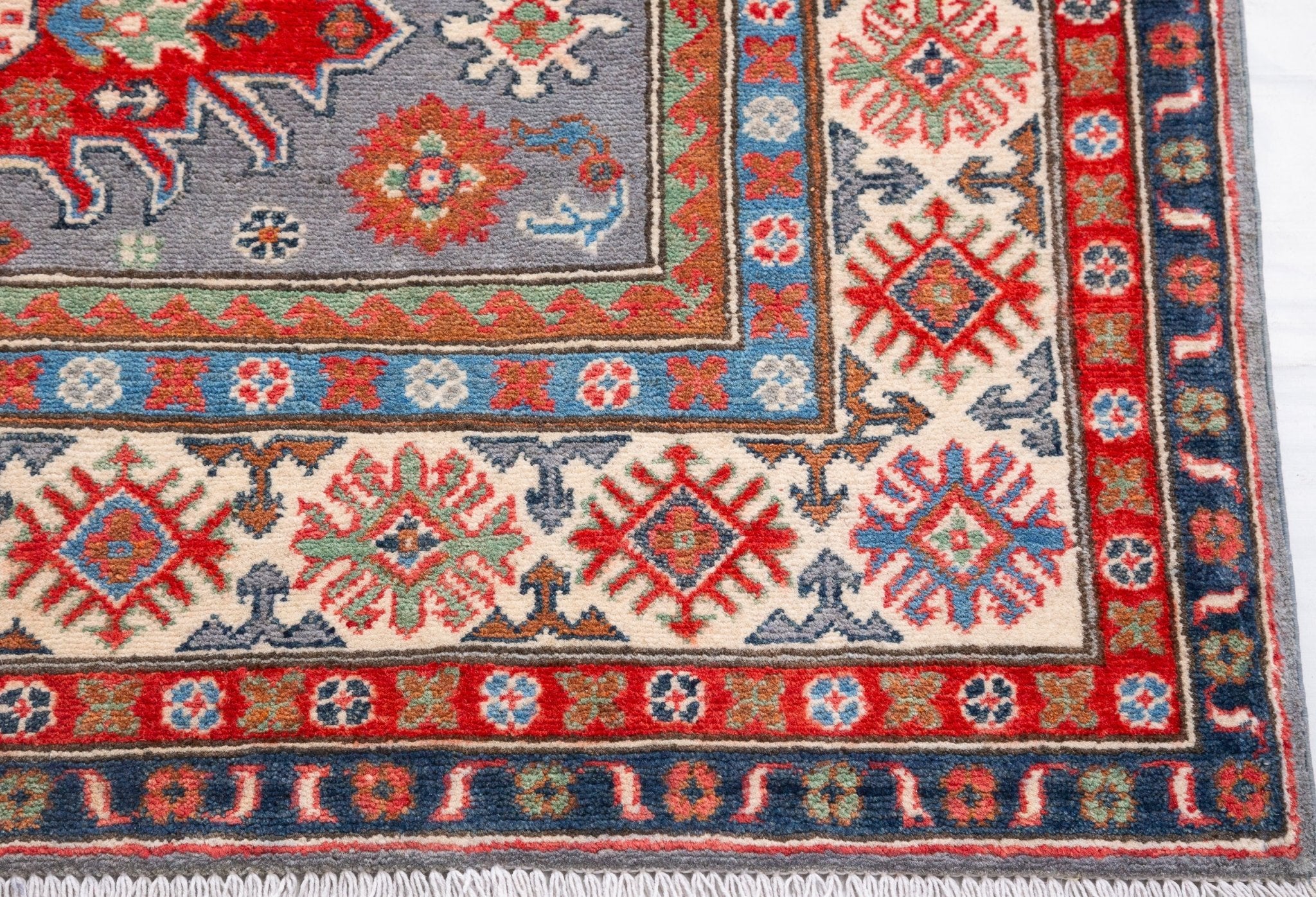 Border and edge detail of blue & red Kazak-inspired wool rug 29345.
