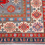 Border and edge detail of blue & red Kazak-inspired wool rug 29345.