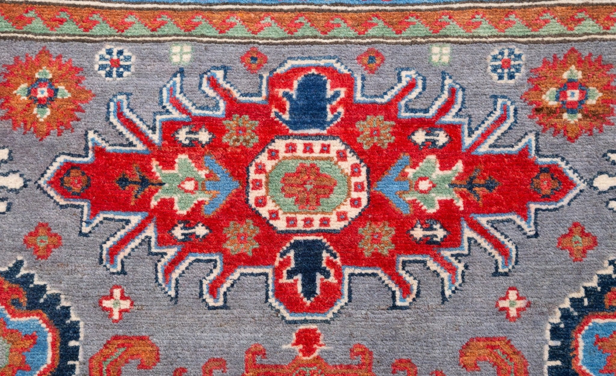 Pattern detail of blue & red Kazak-inspired wool rug 29345.