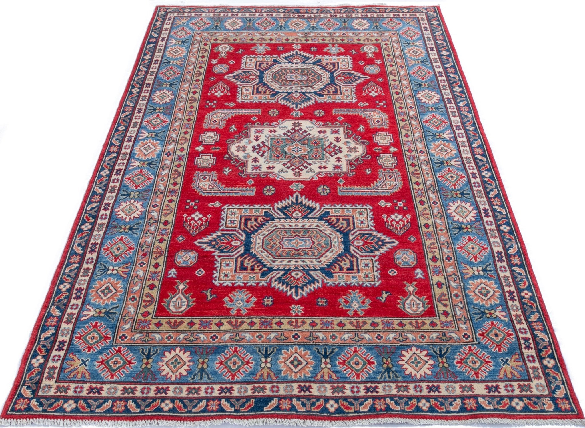 Full view from a low angle of red & blue Kazak-inspired wool rug 21613.