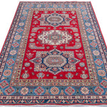 Full view from a low angle of red & blue Kazak-inspired wool rug 21613.