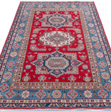 Full view from a low angle of red & blue Kazak-inspired wool rug 21613.