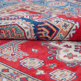 Folded edge and wool pile of red & blue Kazak-inspired wool rug 21613.