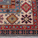 Border and edge detail of blue & red Kazak-inspired wool rug 29339.